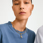 Woman wearing a blue T-shirt and Pilgrim's CHARM flower pendant, gold-plated, on a choker-style necklace, showcasing minimalist elegance and eco-friendly design.
