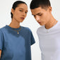 Models showcasing Pilgrim's CHARM crystal coin pendant, gold-plated, on torc necklaces. The pendant, adorned with Preciosa crystals, offers a personalized, eco-friendly touch.