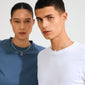 Models wearing Pilgrim's CHARM clover pendant, silver-plated, on smooth tubular chokers. The pendant adds a lucky, stylish touch to their minimalist outfits.