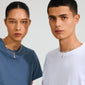 Two young adults model Pilgrim's CHARM f... silver-plated pendant, showcasing its edgy, recycled design with a padlock charm on matching chunky necklaces.