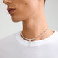 Close-up of Pilgrim's silver-plated CHARM f... pendant necklace, featuring bold letter design, adding an edgy twist to a simple white t-shirt.