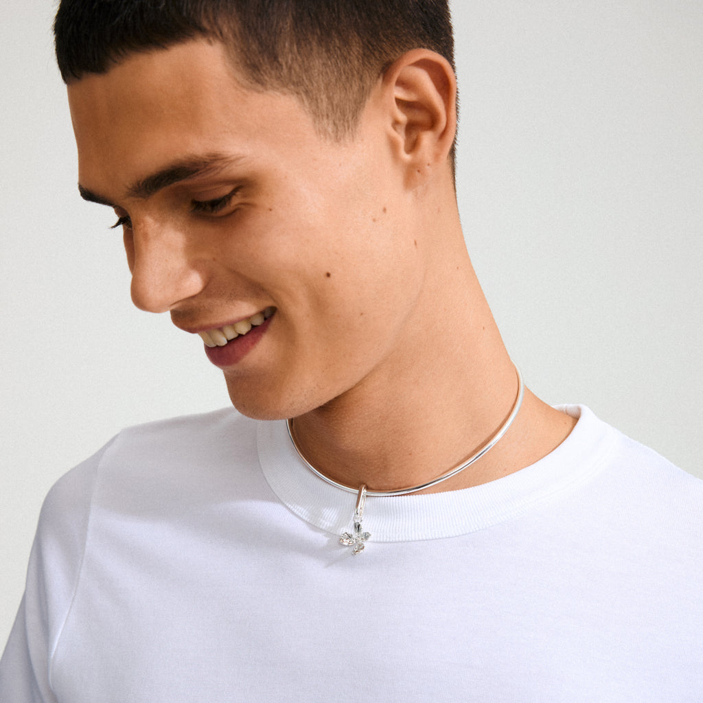 Model wearing Pilgrim's CHARM flower pendant, silver-plated, showcasing a boho flower motif on a slim choker necklace.