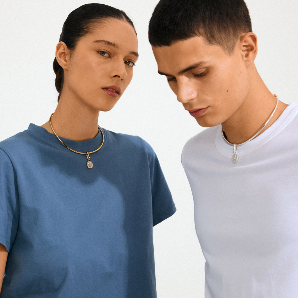 Models showcasing Pilgrim's CHARM crystal coin pendant in silver-plated choker style, featuring sparkling Preciosa crystals for a personalized, eco-friendly fashion statement.