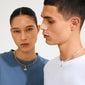 Models showcase Pilgrim's CHARM eye pendant, silver-plated with Preciosa crystals, highlighting its minimalist, trendy design in a studio-lit setting.