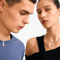 Two models showcase Pilgrim's CHARM bright pendant, a silver-plated necklace featuring a star-sun pendant with a Tiger Eye stone, embodying style and strength.