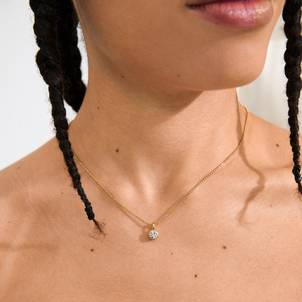 Gold-plated CHARM mini crystal pendant adds a sparkling touch to jewelry, perfect solo or with other charms. Made from 85% recycled, water-resistant materials.