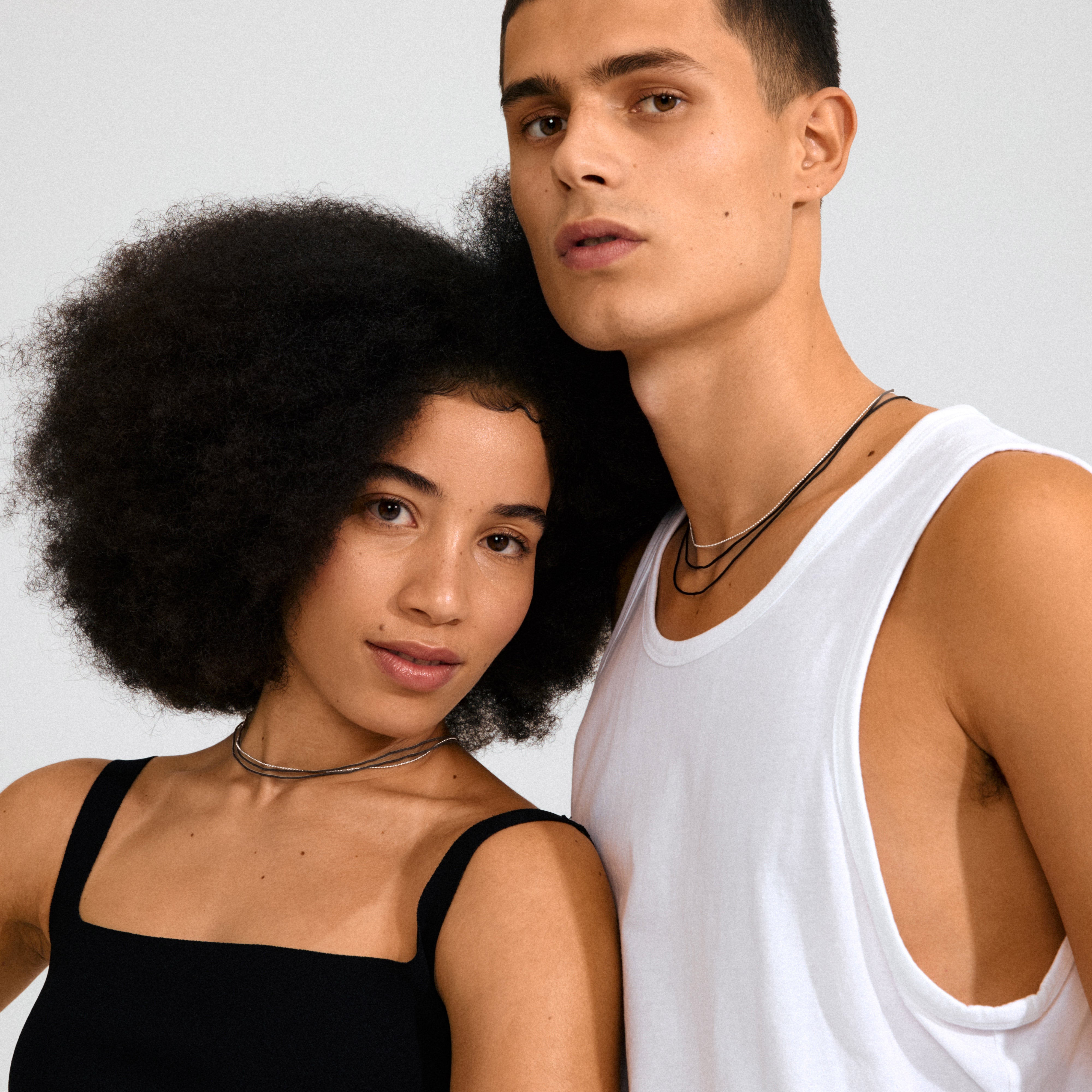 The CHARM necklace 2-in-1 set features a silver-plated bead chain and a long black cotton cord, ideal for adding personalized charms.