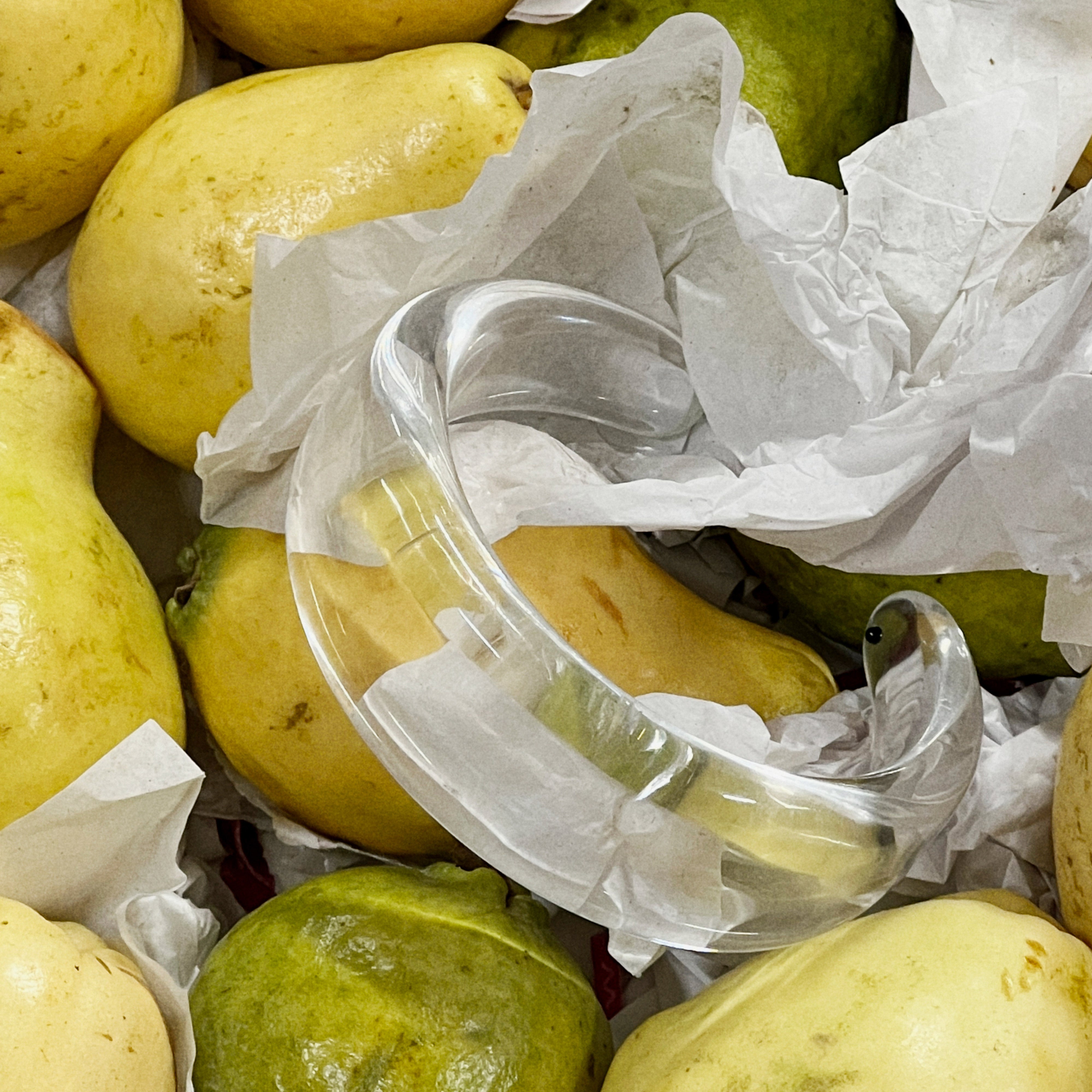 FREJA WEWER x PILGRIM Aqua bracelet nestled on pears, showcasing its chunky, transparent design. A stylish, sustainable accessory crafted from recycled materials.