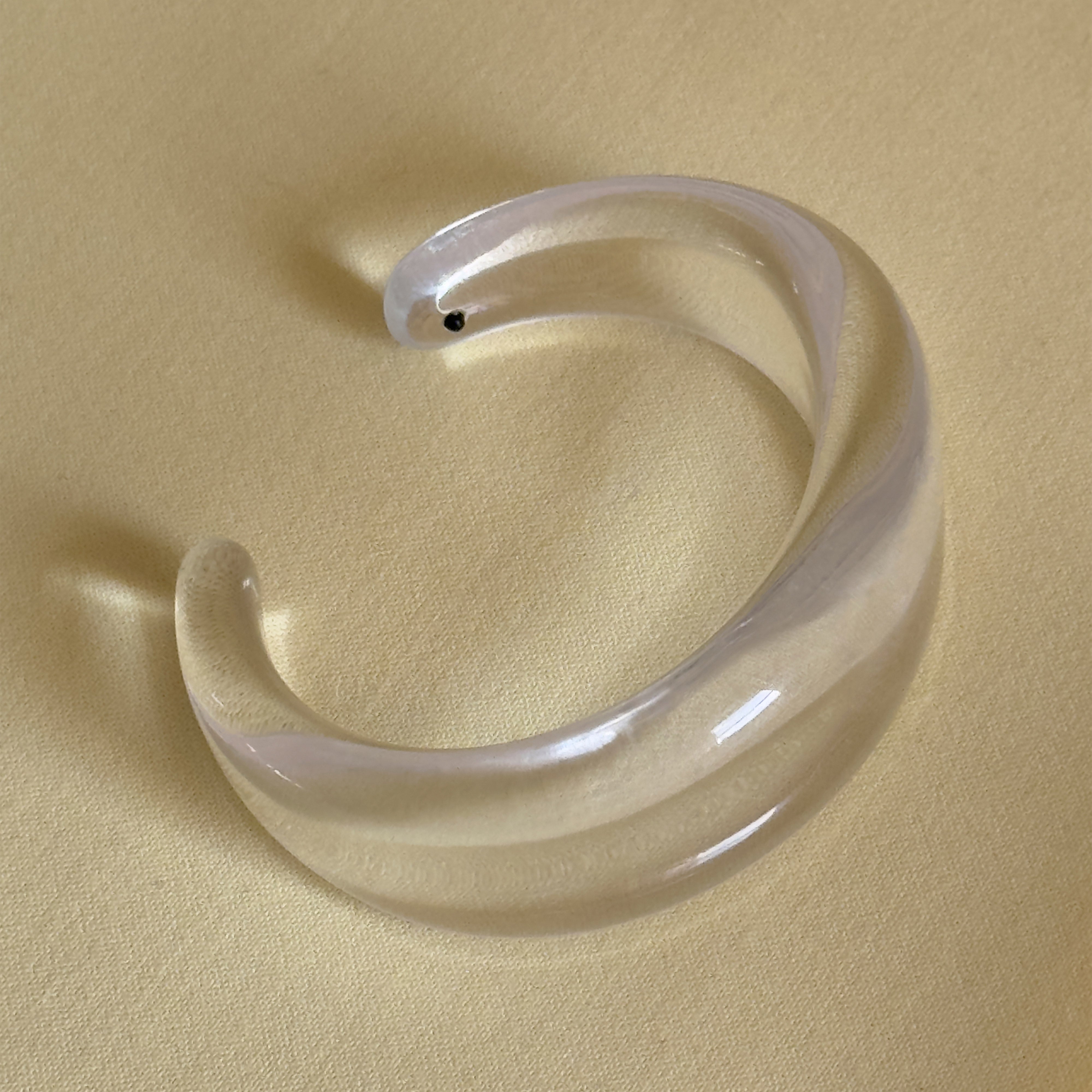 FREJA WEWER x PILGRIM Aqua bracelet, crystal: A chunky, clear acrylic cuff with a sleek design, perfect for solo wear or stacking. Made from 100% recycled material.