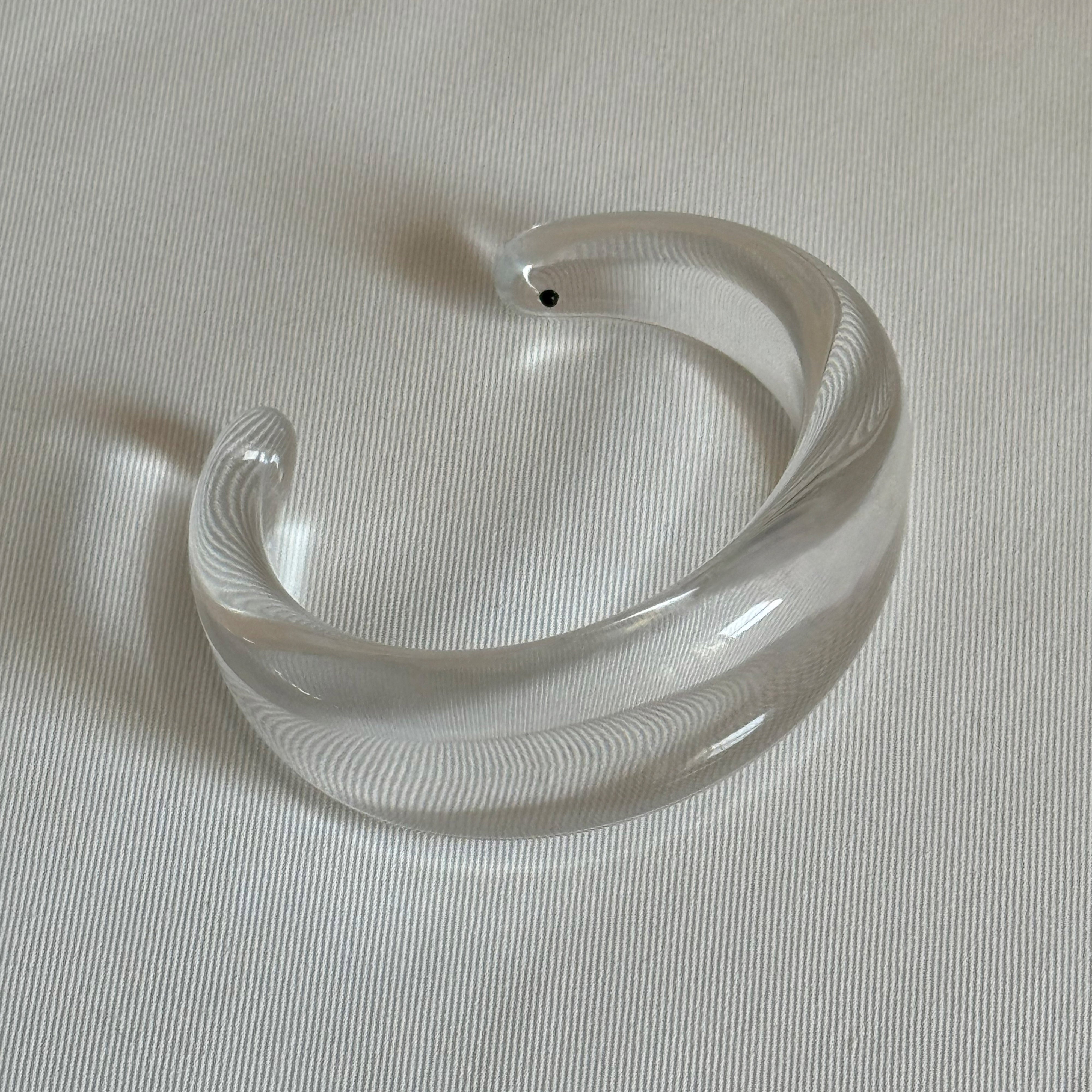 FREJA WEWER x PILGRIM Aqua bracelet, crystal: Chunky, open-ended transparent bangle, crafted from 100% recycled material, showcasing a sleek and stylish design.