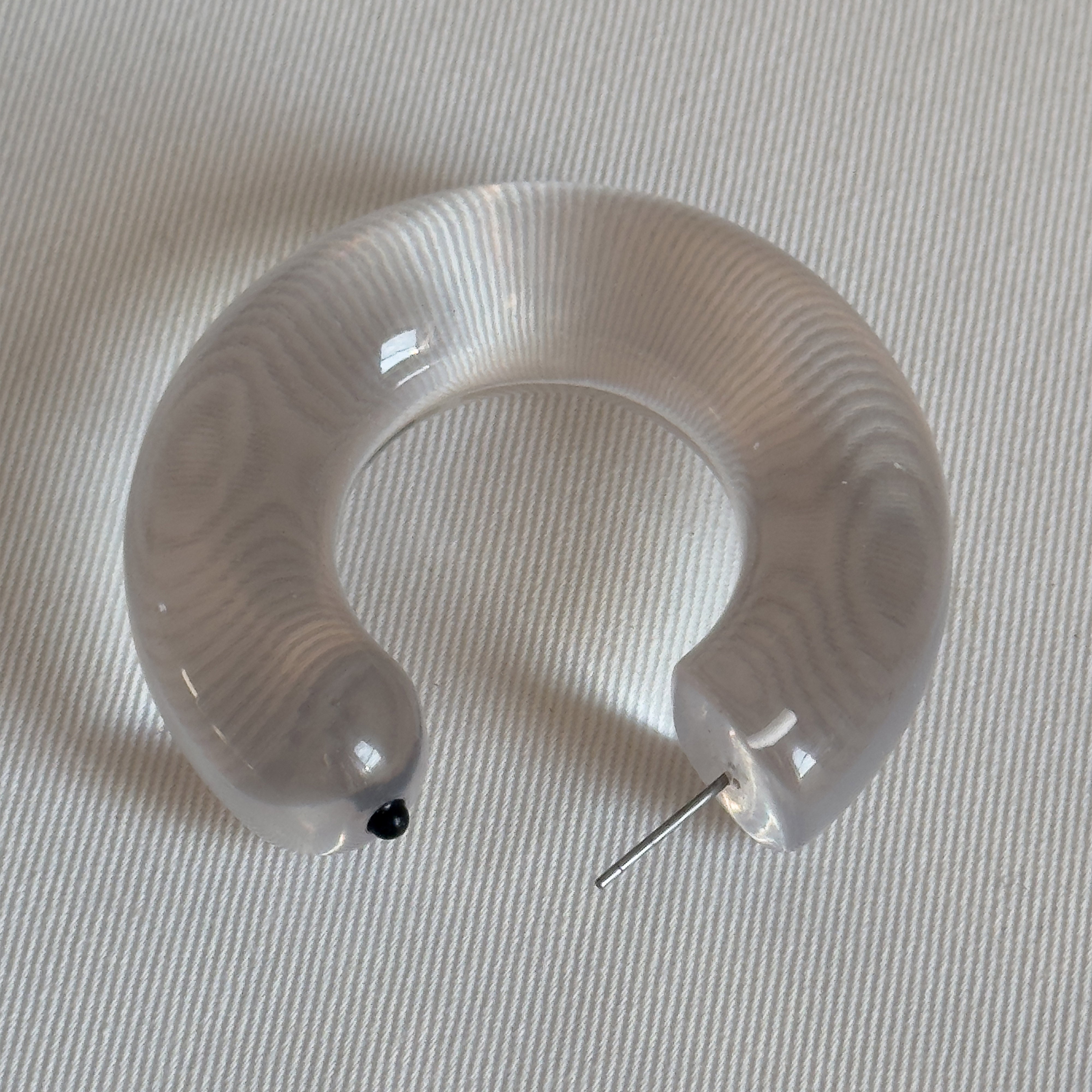 FREJA WEWER x PILGRIM Aqua hoops large, crystal; chunky semi-circular acrylic earrings with metal post, stylishly designed for trendsetters, made from 98% recycled material.