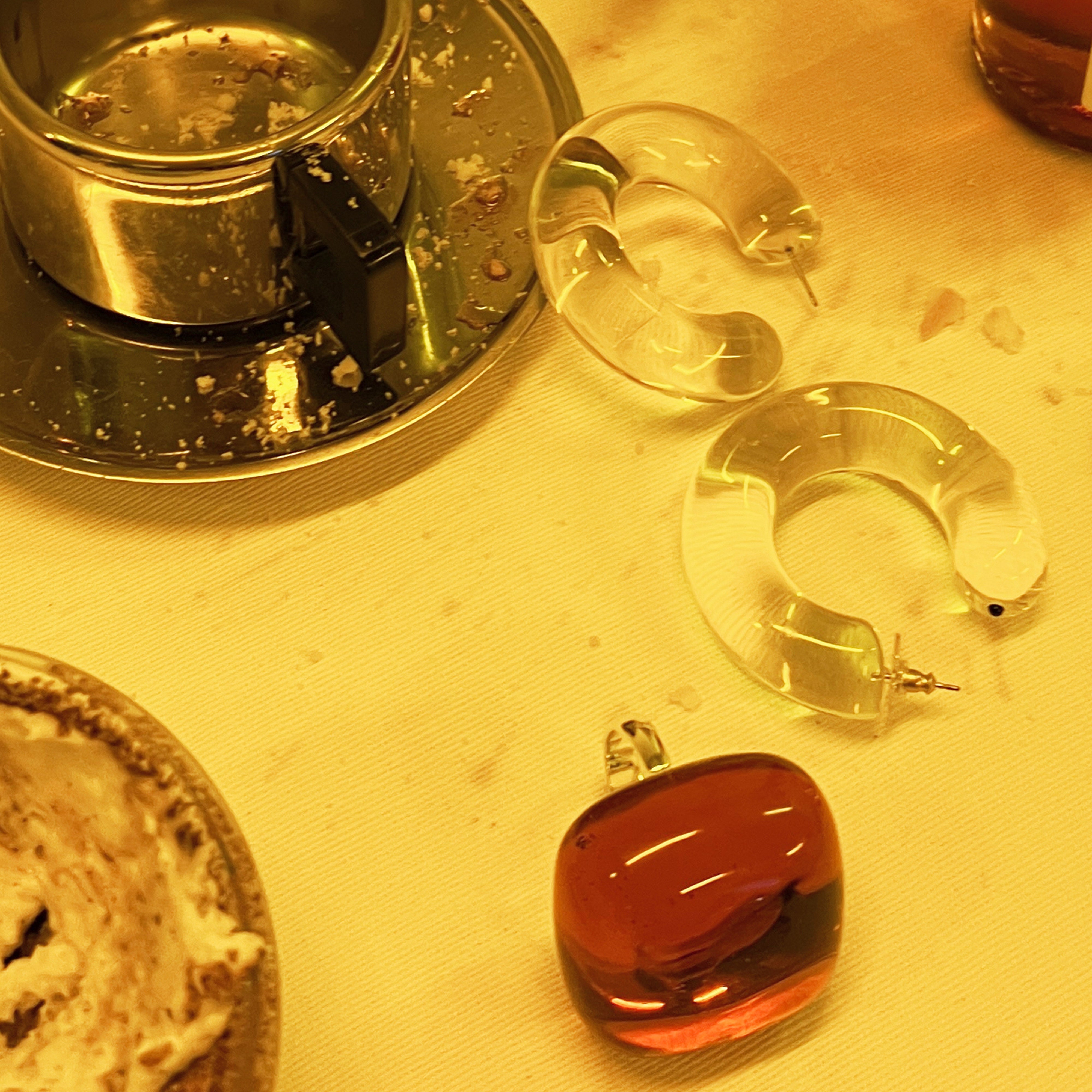 FREJA WEWER x PILGRIM Aqua hoops large, crystal earrings on a table, emphasizing their chunky, trendy design made from 98% recycled material.