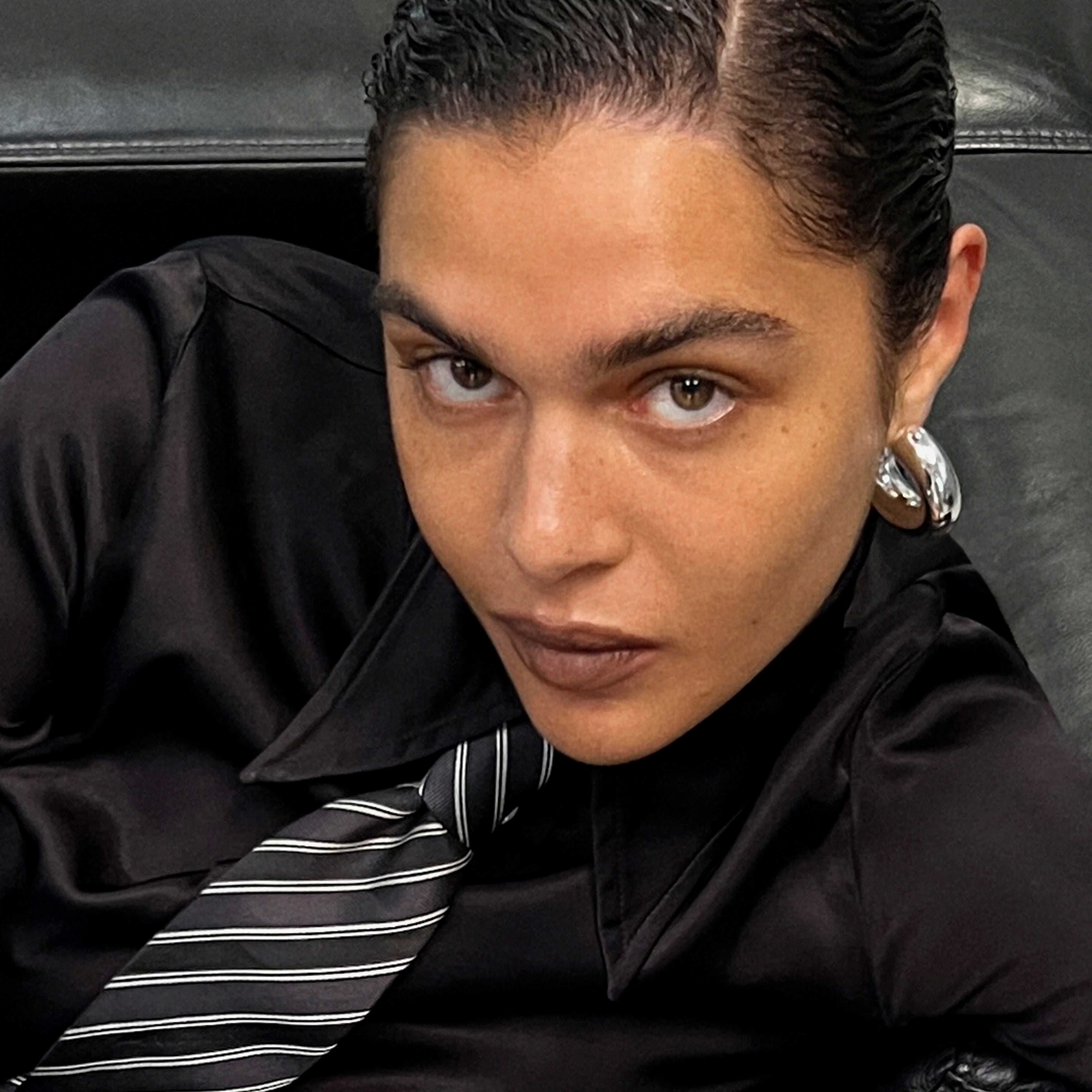 Woman wearing FREJA WEWER x PILGRIM Firenze hoops, medium silver-plated, showcasing their bold, chunky silhouette.