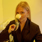 Woman holding a white rose, showcasing FREJA WEWER x PILGRIM Firenze medium silver-plated hoops, highlighting their bold, chunky design for stylish accessorizing.