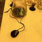 FREJA WEWER x PILGRIM Polpo necklace displayed in a glass jar, featuring a black recycled acrylic pendant on a 120 cm adjustable black fabric cord.