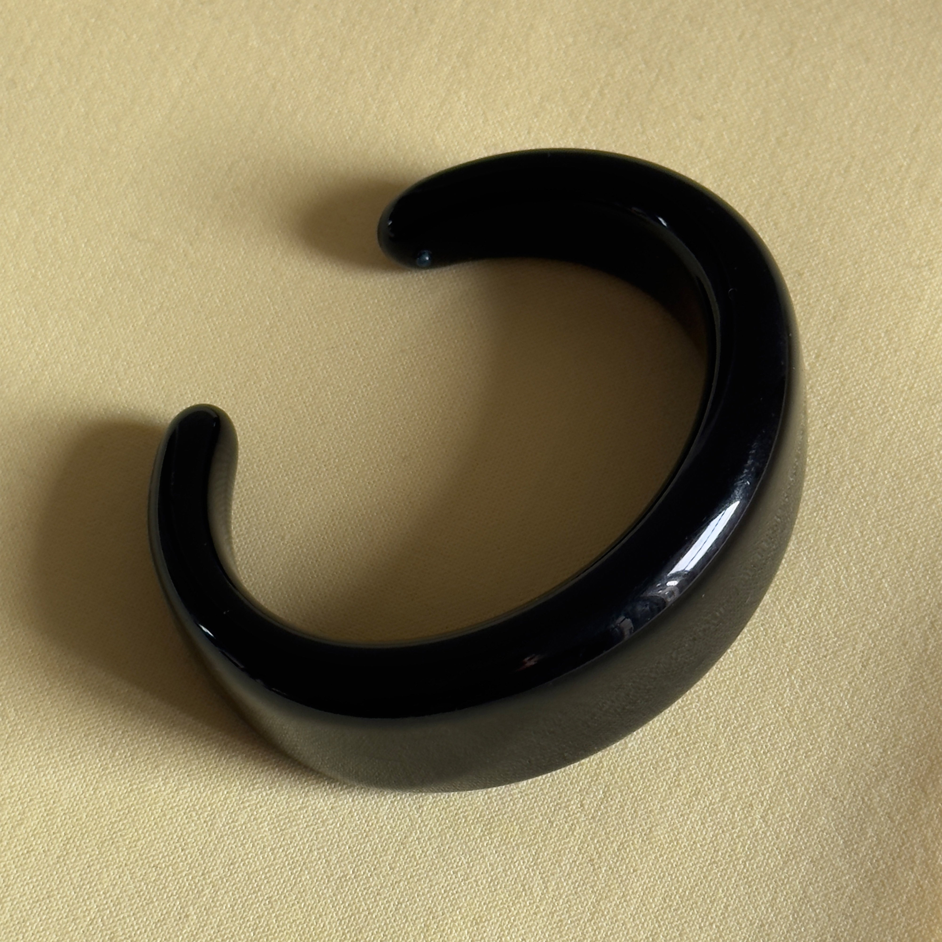 FREJA WEWER x PILGRIM Polpo bracelet, black; a chunky, sleek acrylic bangle, perfect for bold statements or stacking, made from 100% recycled materials.