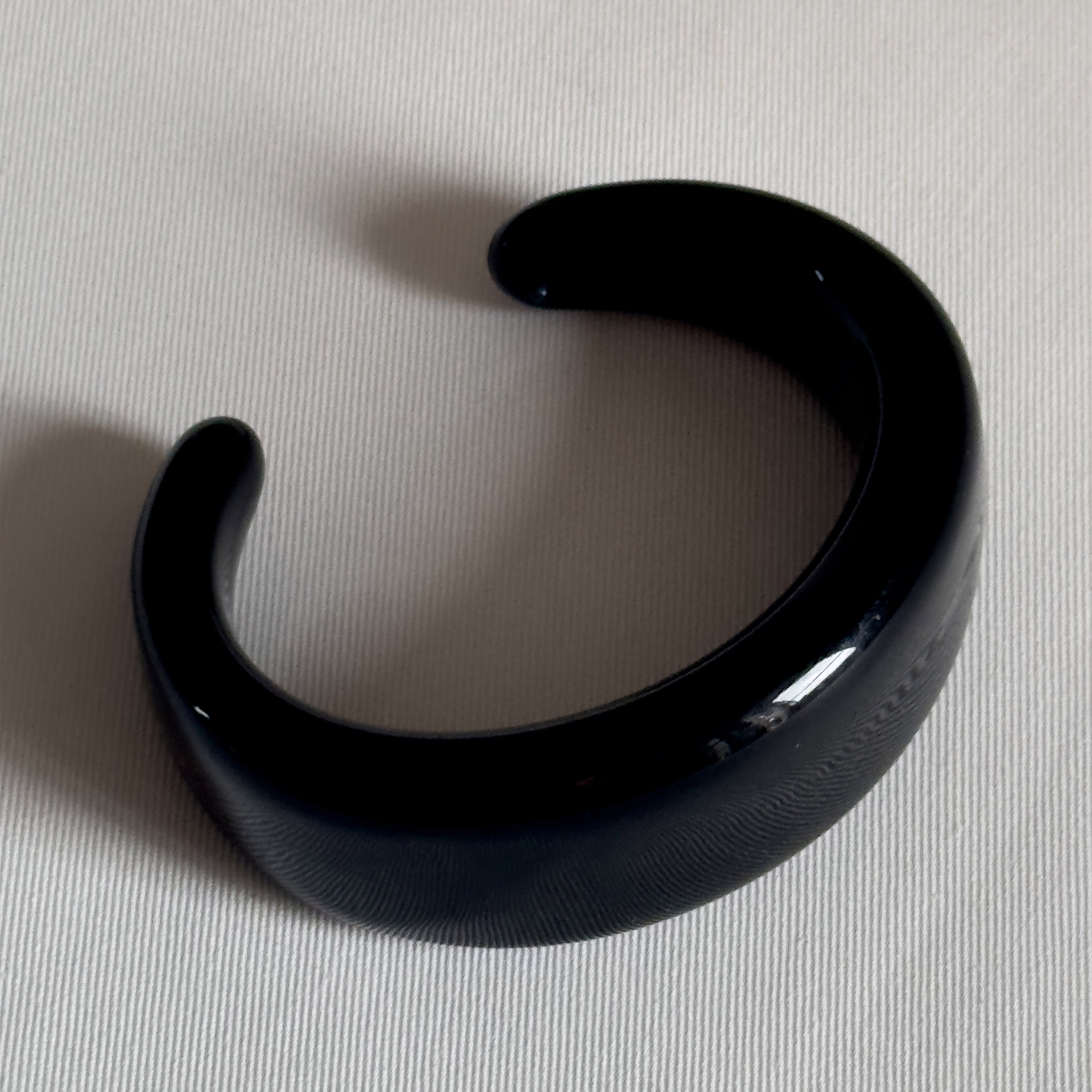 FREJA WEWER x PILGRIM Polpo bracelet, black, featuring a chunky acrylic design made from 100% recycled material, displayed on a white surface.