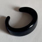 FREJA WEWER x PILGRIM Polpo bracelet, black, featuring a chunky acrylic design made from 100% recycled material, displayed on a white surface.