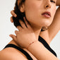 Close-up of a woman wearing the JUNE birthstone bracelet featuring an adjustable red cotton cord and Moonstone, symbolizing intuition and self-discovery.
