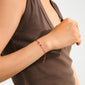 OCTOBER birthstone bracelet on arm, featuring red cotton cord and Opal, symbolizing creativity. A delicate, adjustable accessory for a boho-inspired, personal style.