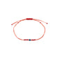 SEPTEMBER birthstone bracelet featuring a red cotton cord with an adjustable knot and a small Lapis bead, symbolizing wisdom and strength.