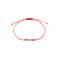 AUGUST birthstone bracelet featuring a red cotton cord with a gold bead and Peridot stone, embodying luxe boho style and Scandinavian craftsmanship.