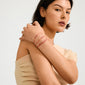 Young woman wears the FEBRUARY birthstone bracelet, featuring red cord with an Amethyst bead, showcasing a delicate, boho style accessory.
