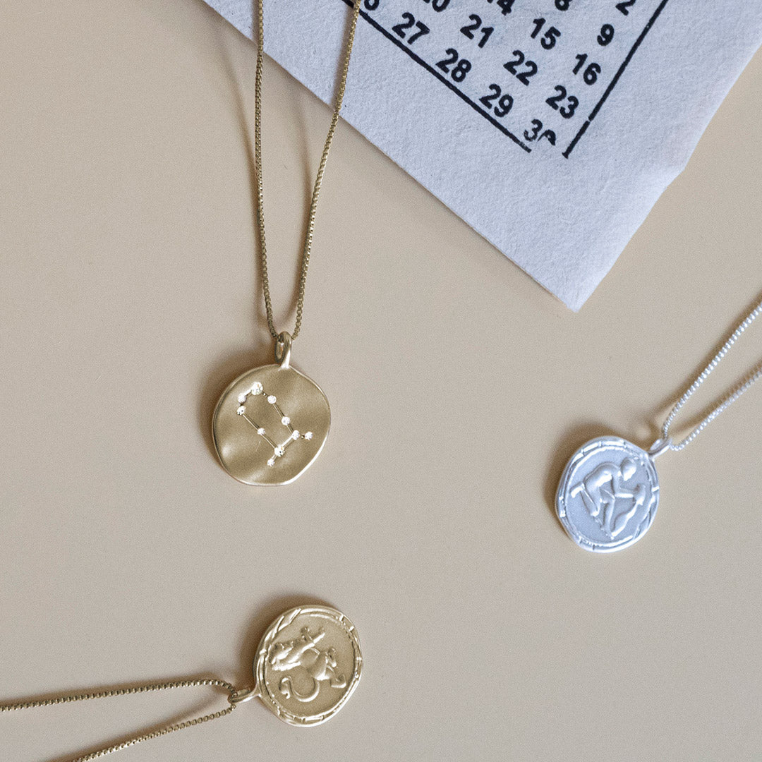 GEMINI Zodiac Sign Coin Necklace, gold-plated, featuring a double-sided pendant with zodiac and constellation motifs, adjustable chain included.
