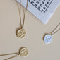 GEMINI Zodiac Sign Coin Necklace, gold-plated, featuring a double-sided pendant with zodiac and constellation motifs, adjustable chain included.