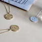 LEO Zodiac Sign Coin Necklace, gold-plated, featuring a double-sided pendant with zodiac motif and constellation in crystals, adjustable chain length for personalized fit.