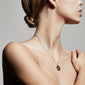 VIRGO Zodiac Sign Coin Necklace, gold-plated, featuring a double-sided medallion with zodiac and constellation motifs, on a woman's neck.