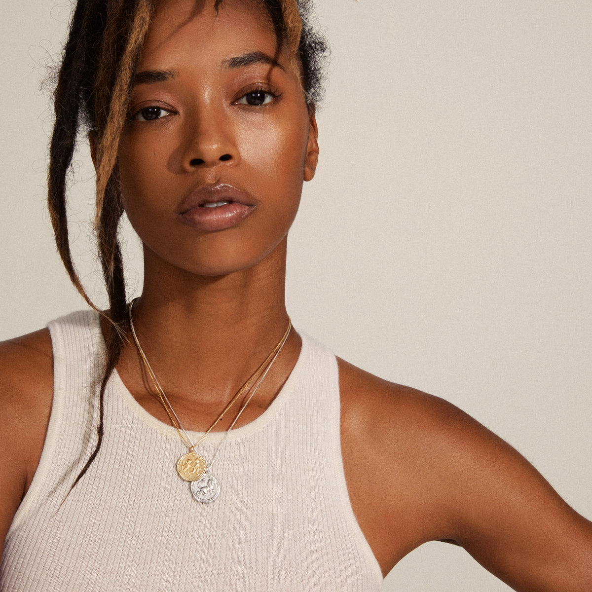 SCORPIO Zodiac Sign Coin Necklace, gold-plated, featuring a double-sided pendant with zodiac motif and crystal constellation, worn by a woman in a white tank top.