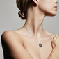 LEO Zodiac Sign Coin Necklace, silver-plated, featuring a double-sided pendant with a zodiac motif and crystal constellation, worn by a woman showcasing its chic design.