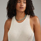 SOULMATES necklace blue/gold-plated on a woman's neck, featuring genuine turquoise and malachite beads, highlighting Pilgrim's unique boho style.