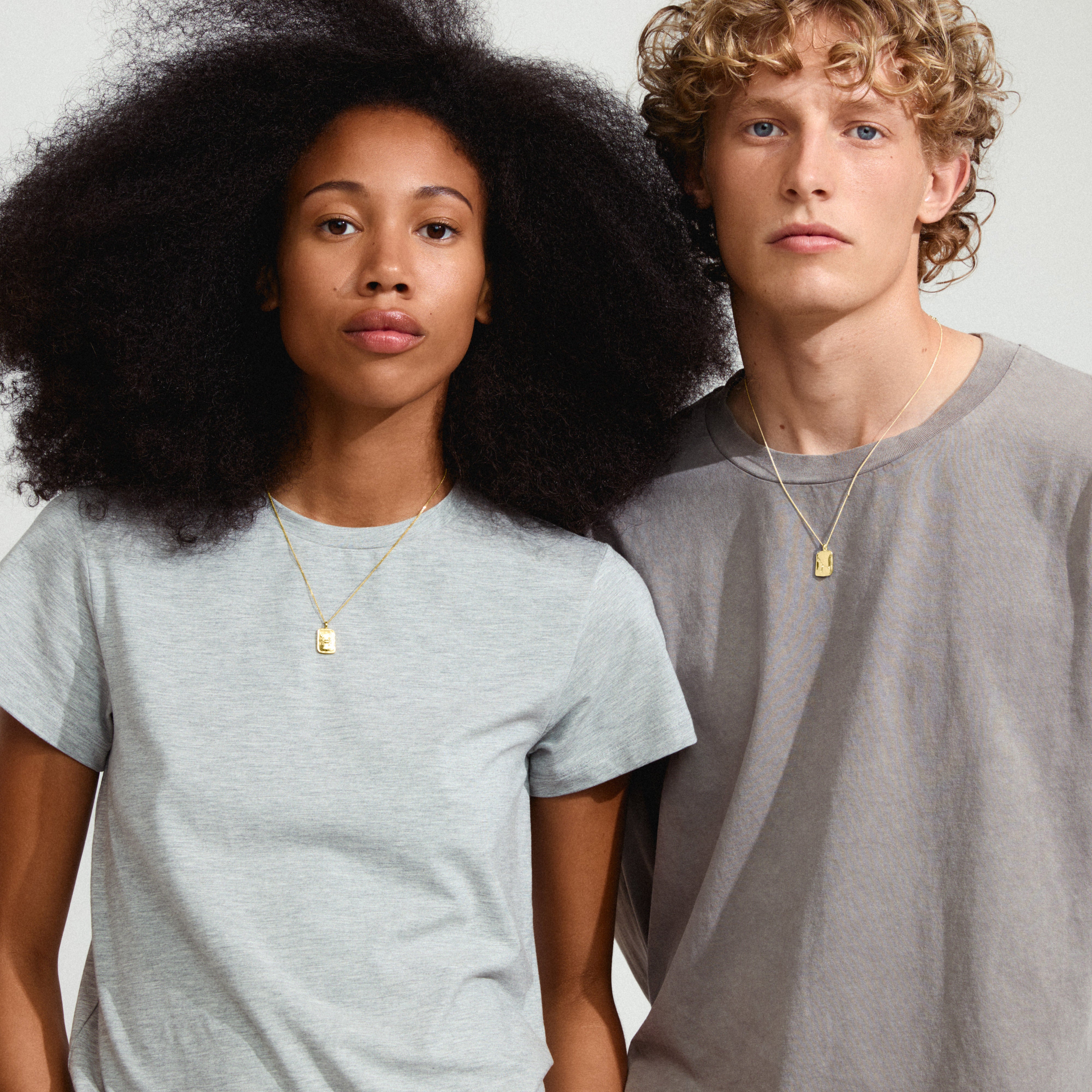 CANCER Zodiac Sign necklace, gold-plated, featuring a dual-design pendant with Cancer zodiac motif and Preciosa crystal constellation, worn by a person.