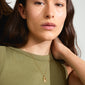 Woman wearing Pilgrim's LEO Zodiac Sign necklace, featuring a gold-plated chain with a reversible square coin pendant in a Leo motif and constellation design.