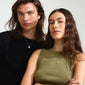 LEO Zodiac Sign necklace with silver-plated chain and square coin pendant, featuring Leo motif and sparkling constellation, worn by a man and woman.