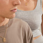 Close-up of two people wearing matching gold-plated LOVE TAG, MOM necklaces by Pilgrim, featuring square pendants spelling “MOMO,” showcasing a stylish, affectionate accessory.