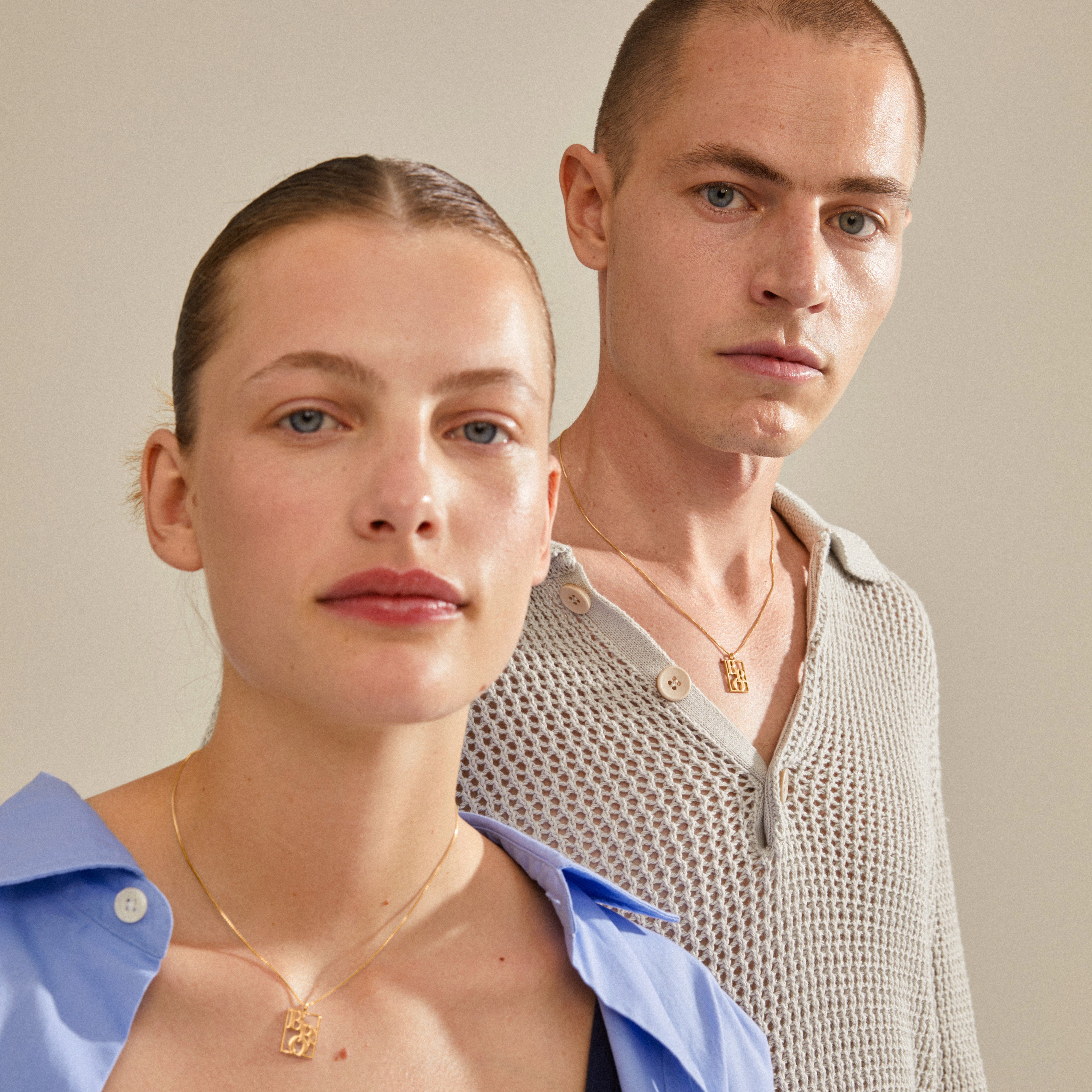 LOVE TAG, BRO necklace gold-plated, worn by a man. Features a square pendant with BRO, adjustable 40 cm + 12 cm chain, made from 99% recycled material.