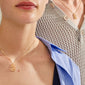 Two people wearing Pilgrim's LOVE TAG, BRO gold-plated necklaces with rectangular pendants, showcasing a trendy layered look against light blue and cream tops.