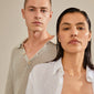 Man and woman showcasing Pilgrim's LOVE TAG, SIS gold-plated necklace with square pendant, ideal for layering. Features adjustable recycled chain for sustainable fashion.