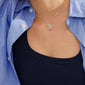 LOVE TAG, BRO necklace silver-plated on a navy tank top, showcasing a square pendant spelling BRO on a delicate silver chain.
