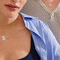Two people wearing Pilgrim's LOVE TAG, BRO silver-plated necklaces, featuring a square pendant with BRO cut-out, showcasing stylish layering over casual outfits.
