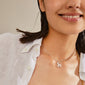 Silver-plated LOVE TAG, SIS necklace featuring a square pendant inscribed with SIS, worn by a woman. Adjustable length with an extension chain.