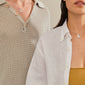 Two women showcase the LOVE TAG, SIS necklace, a silver-plated pendant with SIS on a delicate chain, embodying Pilgrim's blend of timeless and trendy jewelry.