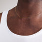 HOPE necklace gold-plated worn by a person; features a sleek design with a cursive 'HOPE' pendant, ideal for layering or solo wear.