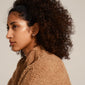 VICTORIA crystal earrings in rose gold, shaped as intertwined rings with bright crystals, worn by a woman with curly hair, showcasing elegant Pilgrim style.