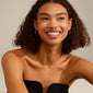 LAYLA medium hoop earrings gold-plated adorn a smiling woman, showcasing their elegant design and user-friendly click clasp, perfect for elevating any ensemble.