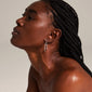 LAYLA large hoop earrings silver-plated worn by a woman with braided hair looking up, showcasing elegant, medium-sized creoles enhancing her personal style.