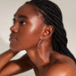 LAYLA large hoop earrings silver-plated on a woman with braided hair, highlighting the earrings' elegant design and user-friendly click clasp.